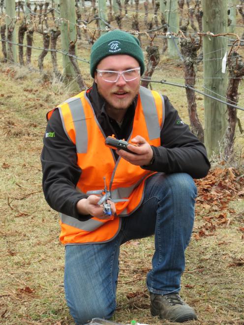 Daniel Brewster, of Akarua Winery, tries to operate a toy helicopter during the competition.