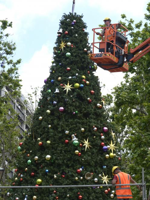 Contractors assemble the 12m Octagon Christmas tree yesterday morning which will be lit in the annual tree lighting ceremony on Friday. Photo: Gerard O'Brien