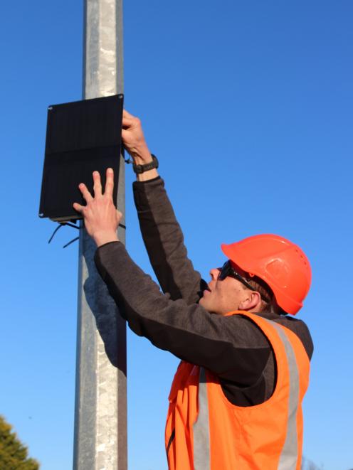 Environment Southland air quality scientist Owen West installing one of the 25 air quality...