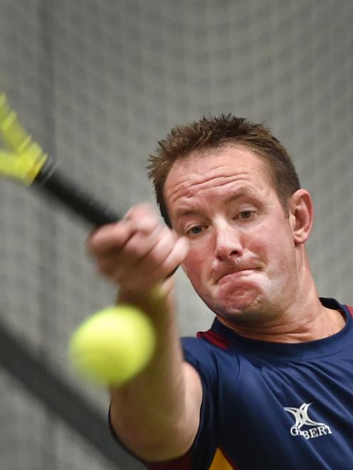 Jason Forrest, of North Otago, watches the ball after playing a shot during a singles match....