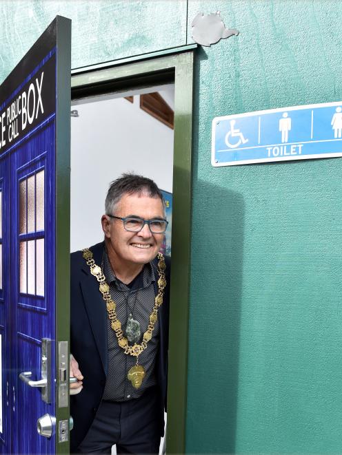 Dunedin Mayor Dave Cull peeks out of "the Turdis", Waitati's new public toilet, following a...