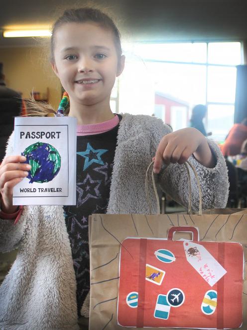 Zoe Brinkworth (7) proudly shows the luggage she created to carry the crafts she did during the...