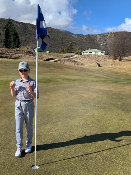 Young Arrowtown golfer Josh Harris celebrates his hole in one at the Arrowtown Golf Club last...