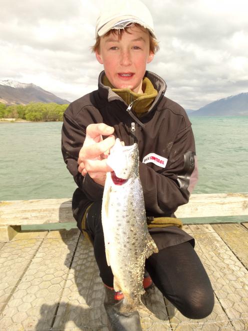 Seamus Hickey (14), of Christchurch, shows off one of the brown trout he caught off the Glenorchy...