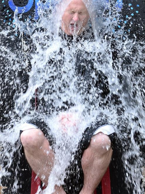 Kaikorai Primary School principal Simon Clarke gets a dunking of cold water, in the name of fund...