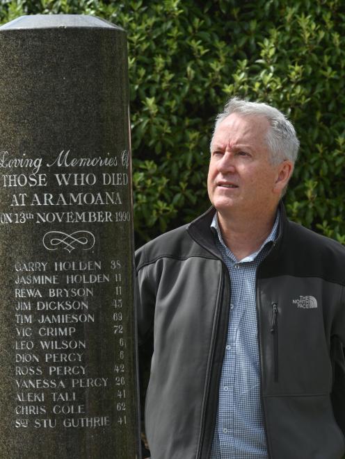 St John intensive care paramedic Doug Flett pays his respects at a memorial to the victims of the...