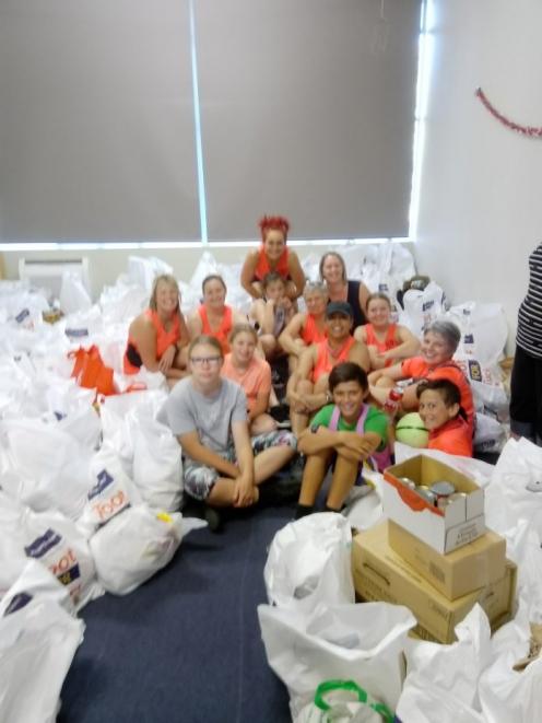 A group of volunteers at Kaiapoi Community Support with some of the food donated during last year...