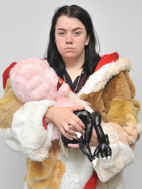 Tess Wing tries on the heavy coat made of stuffed animals while 
...
