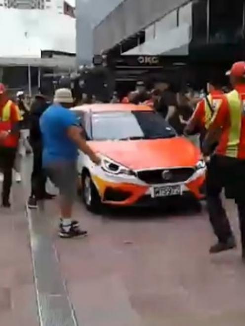 A crowd surrounded a Safety Warehouse car after the company gave out "fake cash" as well as real...