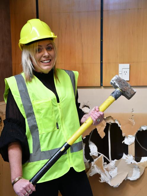 Southland Charity Hospital board trustee Melissa Vining wields a sledgehammer on Monday. PHOTO:...