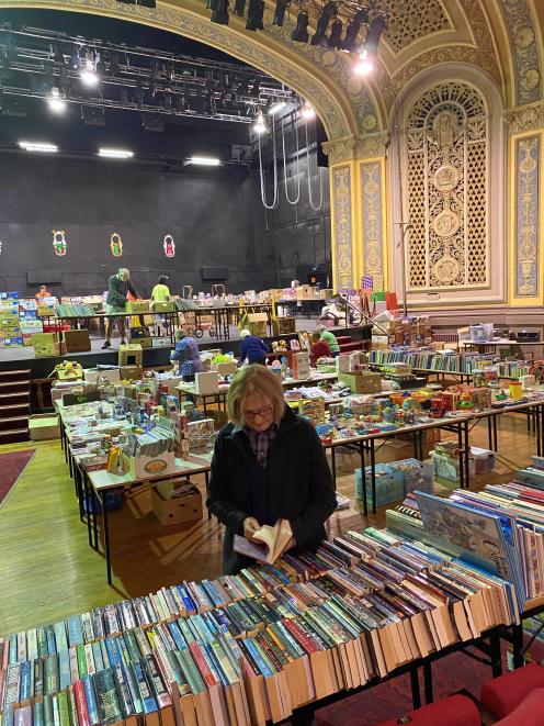 Regent Theatre volunteer Penny Smith and fellow volunteers prepare for the ‘‘Good as New’’ book...