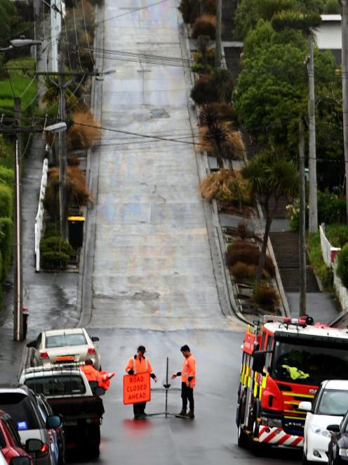 Firefighters cordoned off Baldwin St, in Dunedin, yesterday 
...