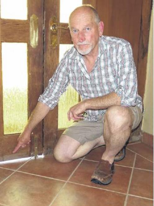 Black Ridge Vineyard director Joss Purbrick shows the water line in his cellar door tasting room;...