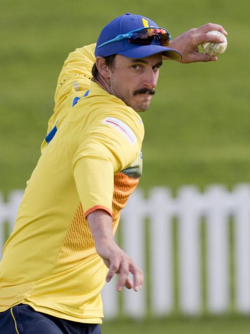 Otago top order batsman Hamish Rutherford fields the ball during a training session at the...