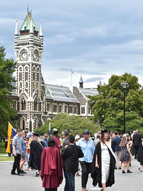 Graduands and their families make the most of graduation day near the University of Otago clock...