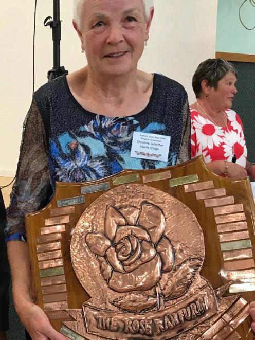 North Otago Rose Society president Christine Schaffer holds the South Island Rose Ranfurly Shield...