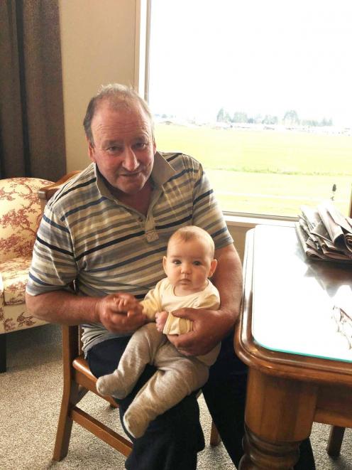 Te Anau farmer and crayfisherman Anthony Lush with his first granddaughter, Eva Erskine, in 2016....