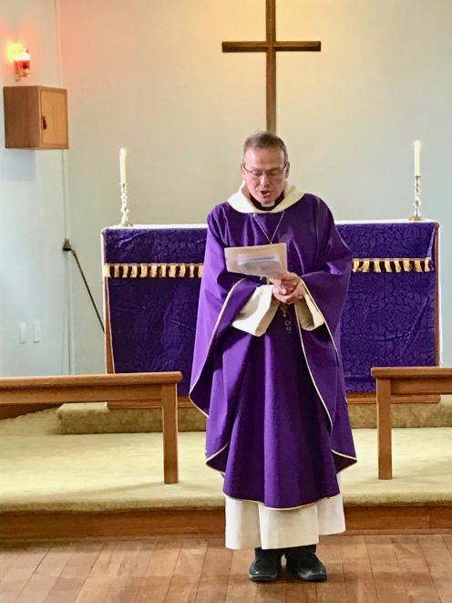 Anglican Bishop of Dunedin Steven Benford reads the formal document of deconsecration.