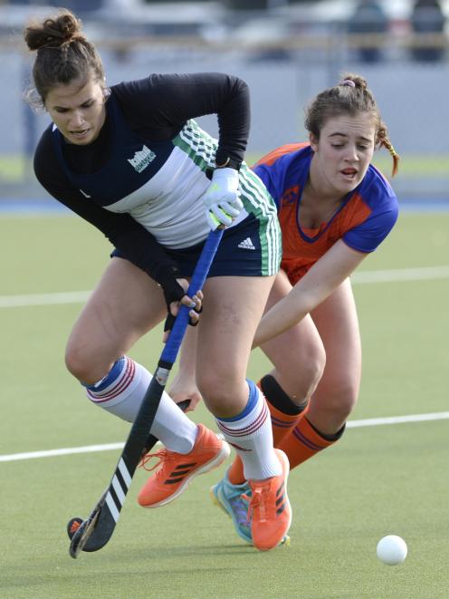Disputing possession in a match at the McMillan Hockey Centre are Maddie Peel (left) of King’s...