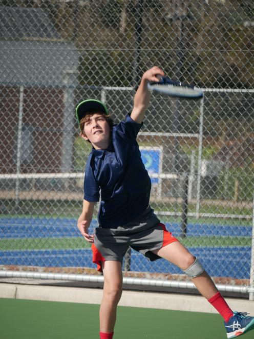 Mathew Campbell (12), of Dunedin, reaches for his shot during a match in the Stevenson Junior...