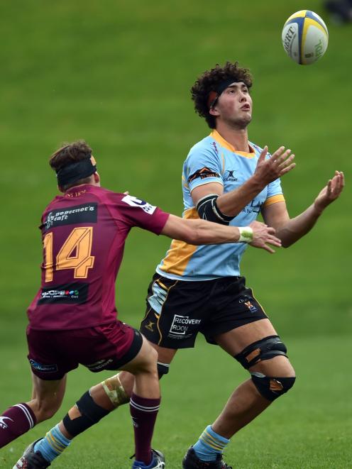 University loose forward Josh Hill looks to catch the ball while under pressure from Alhambra...