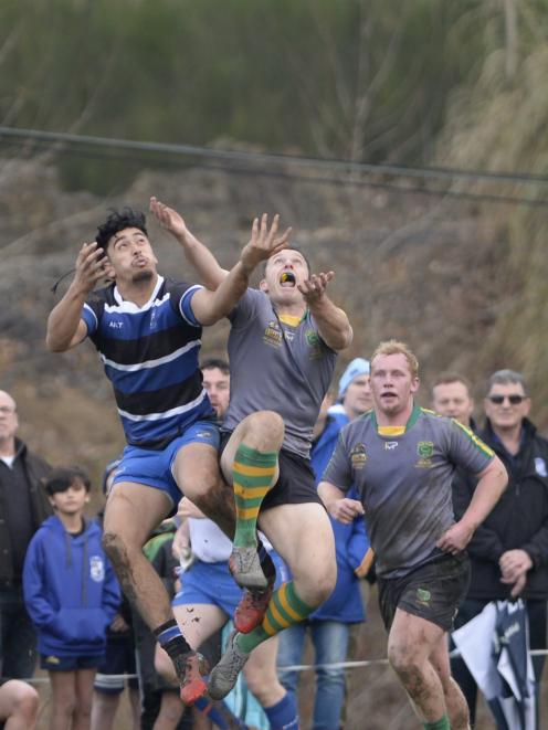 Green Island fullback Ben Smith (right) competes for a high ball with Kaikorai winger Layne...
