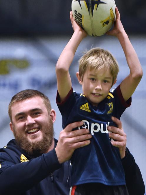 Highlander Jeff Thwaites lifts Levi Stafford (7) of Dunedin during Highlanders coaching kids at...