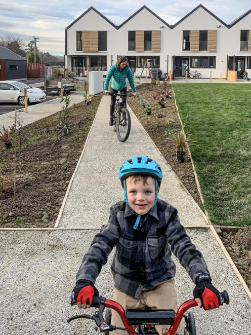 Arlo Ross (5) and his mother, Philippa, head out on a bike ride. Shutters on the exterior of the...