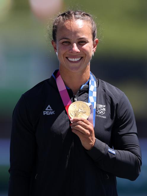 Lisa Carrington shows off the latest gold medal in her incredible collection. Photo: Getty Images