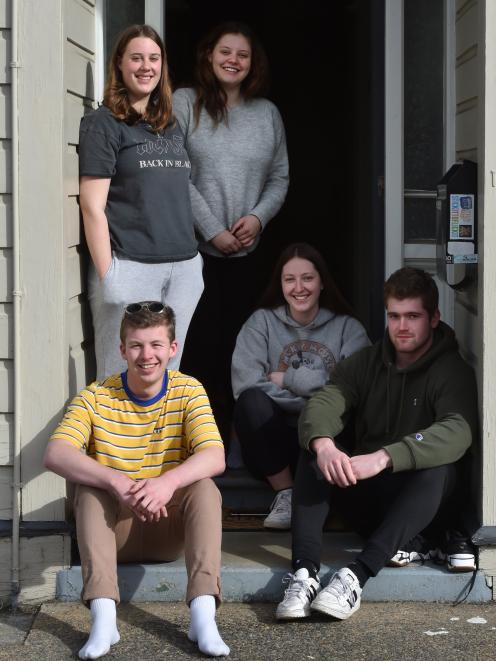 Enjoying the sun in their Dundas St flat bubble yesterday are students (from left) Dylan McEntyre...