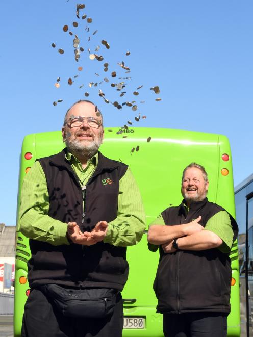 Go Bus drivers Peter Dowden (left) and Philip Matthews celebrate after Go Bus and the Otago...