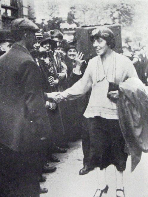Mrs Edgar Lansbury, councillor of the London borough of Poplar, shakes hands with 
...