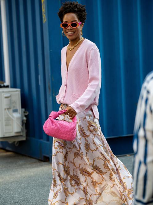 A printed maxi dress is styled with a soft pastel oversized cardi and accessorised with flashes...