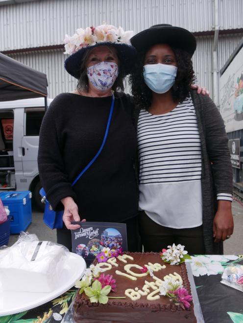 Oamaru Farmers’ Market co-managers Annah Evington (left) and Thaka Mandiwona get ready to cut a...