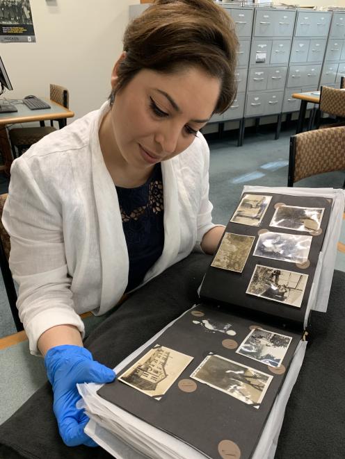 University of Otago PhD candidate Parisa Saadat Abadi Nasab examines historical photos as part of...
