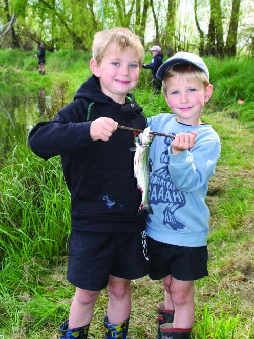 Riverton brothers Conor (5) and Mason (4) McCullough show off their ‘‘catch of the day’’ during...