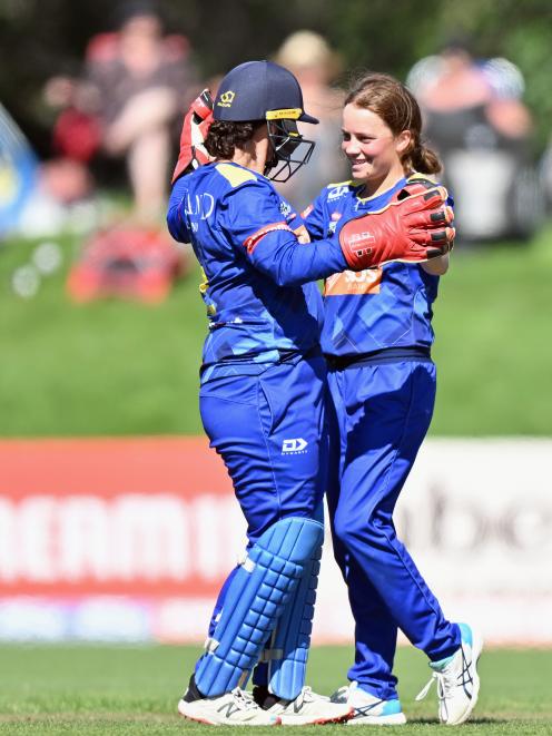 Sparks off-spinner Eden Carson (right) is congratulated by wicketkeeper Katey Martin after...
