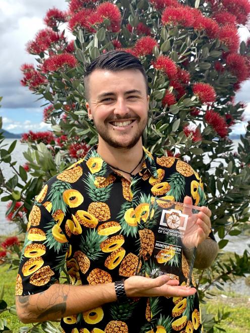 Hunter Smith holds the New Zealand Geographic aerial photograph award trophy. PHOTO: SUPPLIED