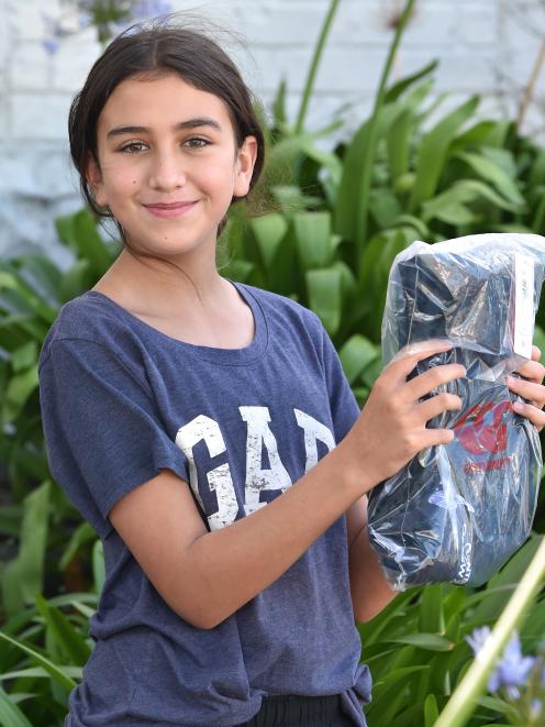 St Hilda's Collegiate School pupil Jahdae Ainsley holds up her newly bought school uniform in...
