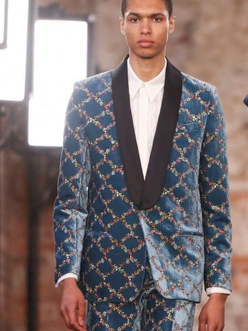 A model steps out in a suit during the Paul & Joe catwalk show at London Fashion Week. Photo:...