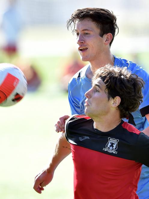 Mosgiel’s Cody Brook (in red) holds off Dunedin City Royals’ Kaleb de Groot during their Southern...