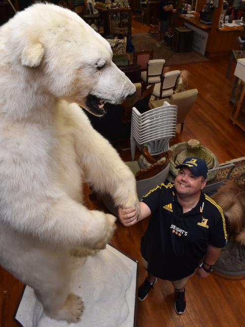 Proctor auctions manager Ronnie Proctor examines Pete the polar bear, the star attraction in a...