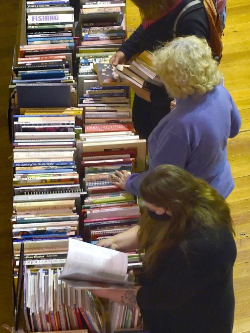 Tables heaving with books were being constantly restocked by the sale’s tireless volunteers while...