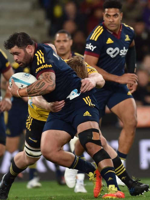 Highlanders prop Jermaine Ainsley carries the ball as replacement centre Fetuli Paea watches...