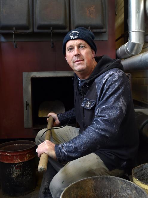 Caretaker Alister Wilden sits beside the broken boiler at Carisbrook School  yesterday. PHOTO:...