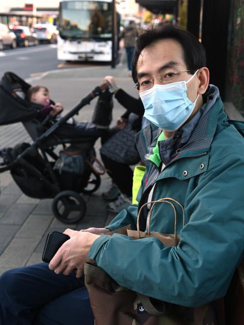 Microbiologist and bus user Siong Loo, of Dunedin, waits for the Shiel Hill bus at Dunedin’s bus...