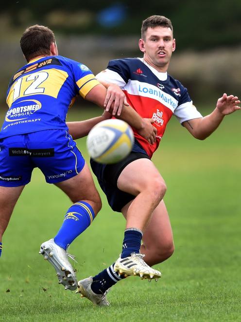 Harbour first five Joshua Robertson-Weepu gets the kick away in the tackle of Taieri defender...