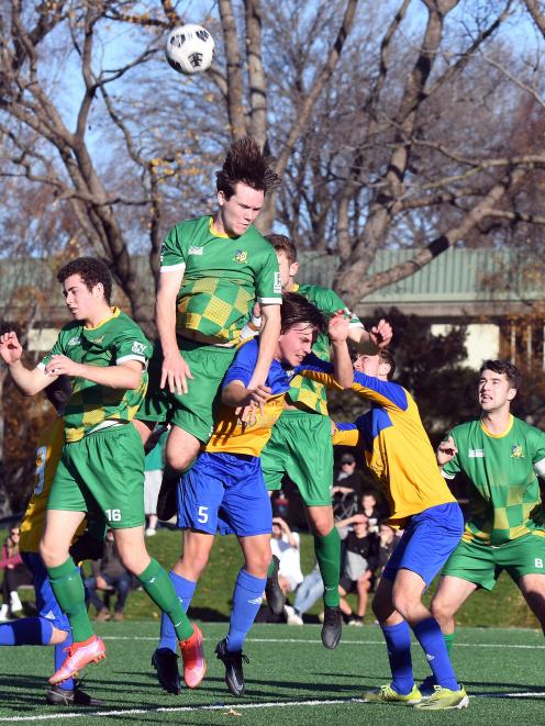 Green Island Alex Cox goes high to heads the ball from a corner in his side’s Chatham Cup third...
