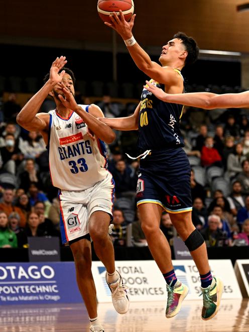 Nuggets guard Nikau McCullough shoots past Giants forward Trey Mourning during their NBL clash at...