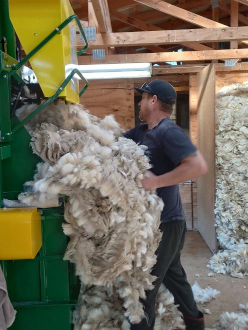 Presser Michael Hines fills the wool-press in the Glenspec woolshed. PHOTOS: SALLY RAE